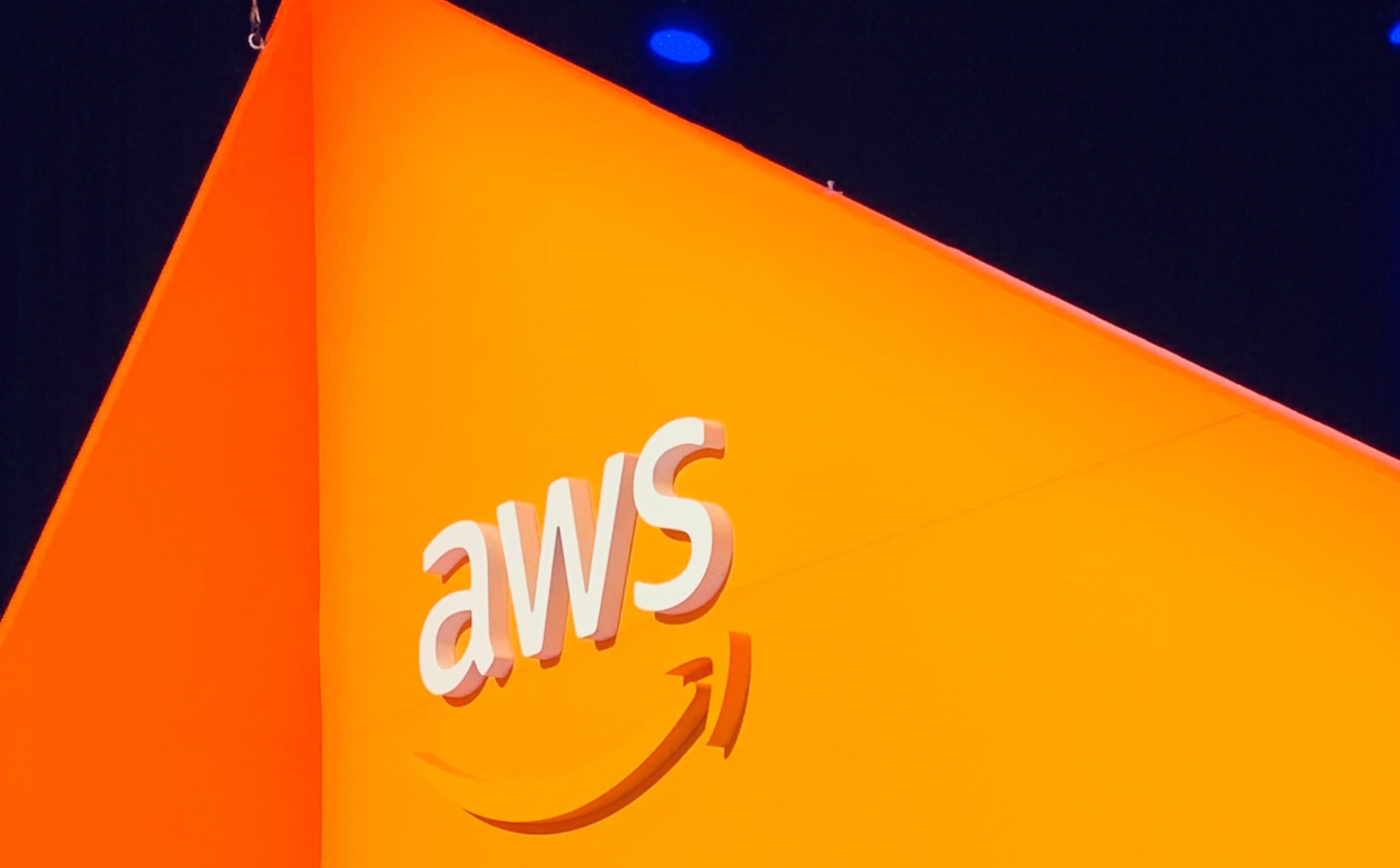 AWS logo against orange background