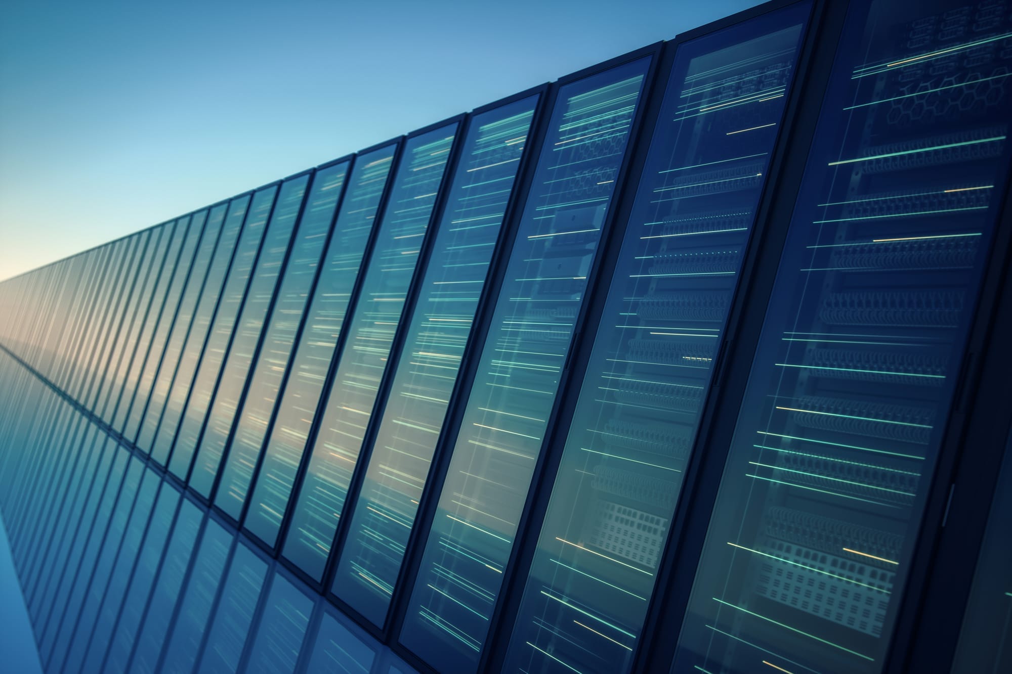 Rows of data center server racks behind glass panels