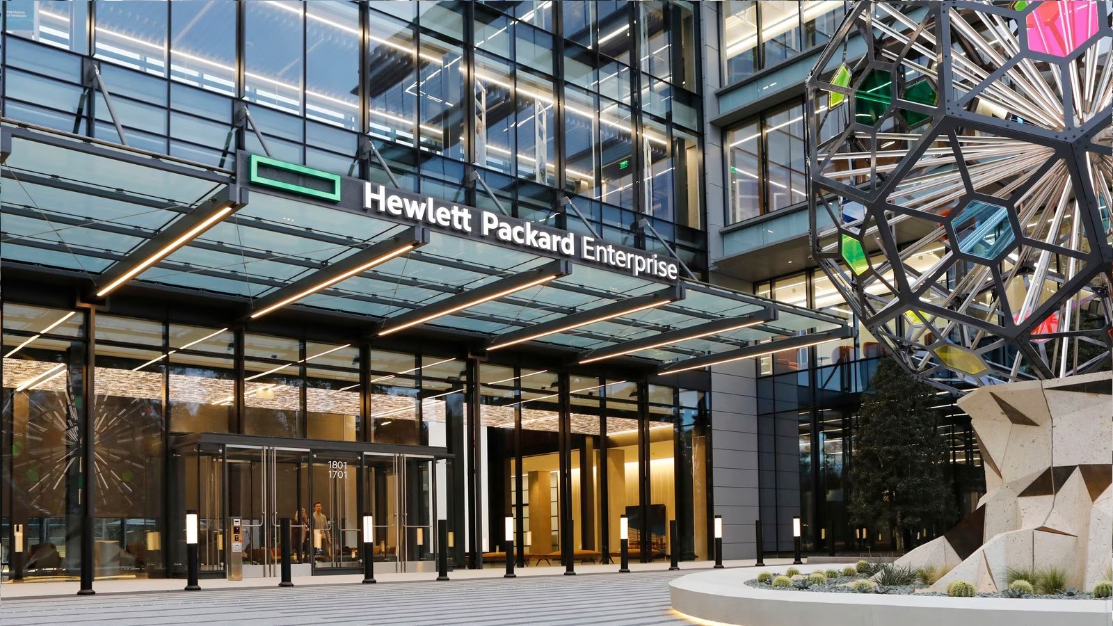 HPE Houston Campus.View is front of glass building with Hewlett Packard Enterprise logo over marquis at front of building.