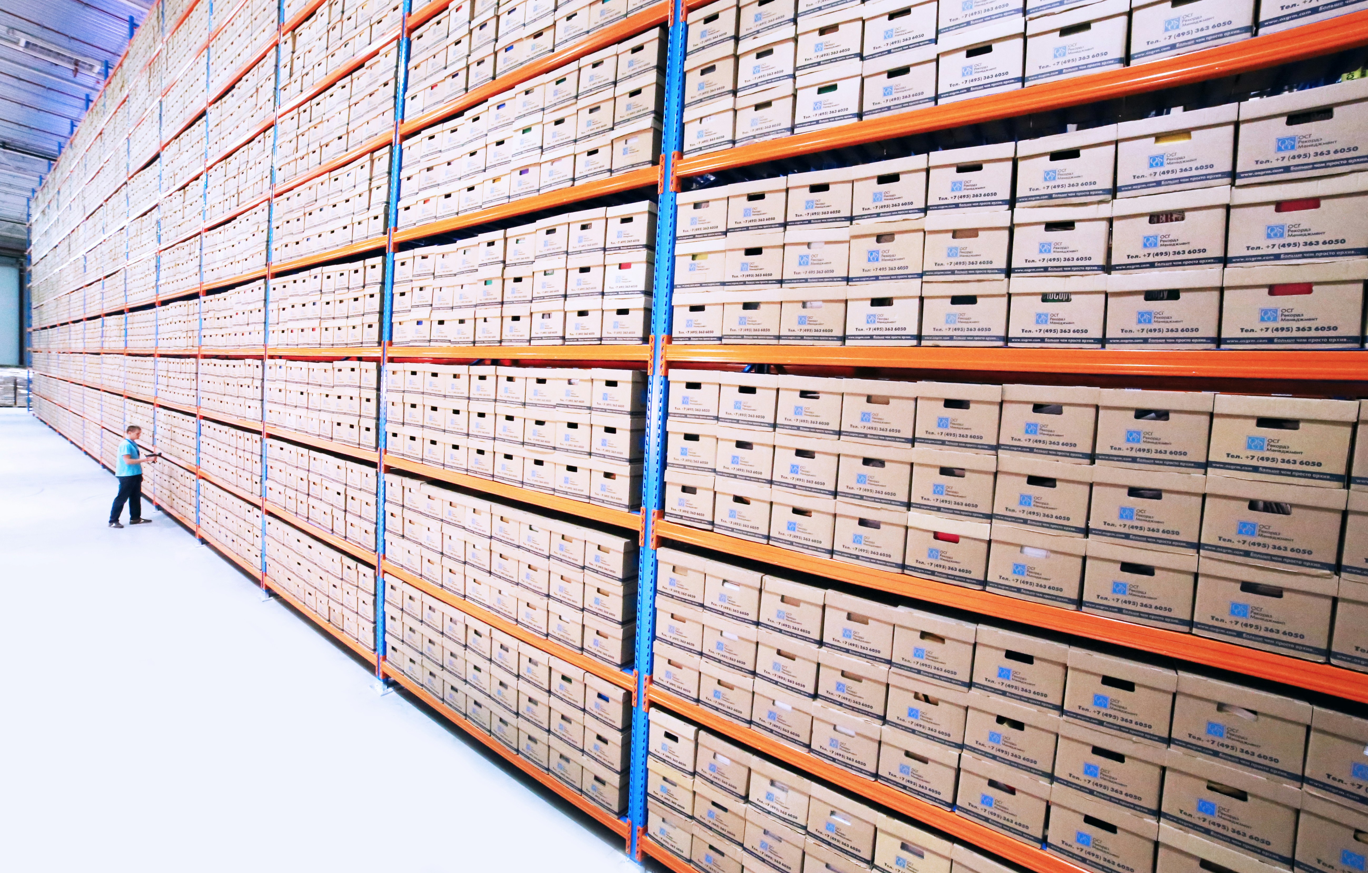 Rows of neat file boxes in a warehouse.