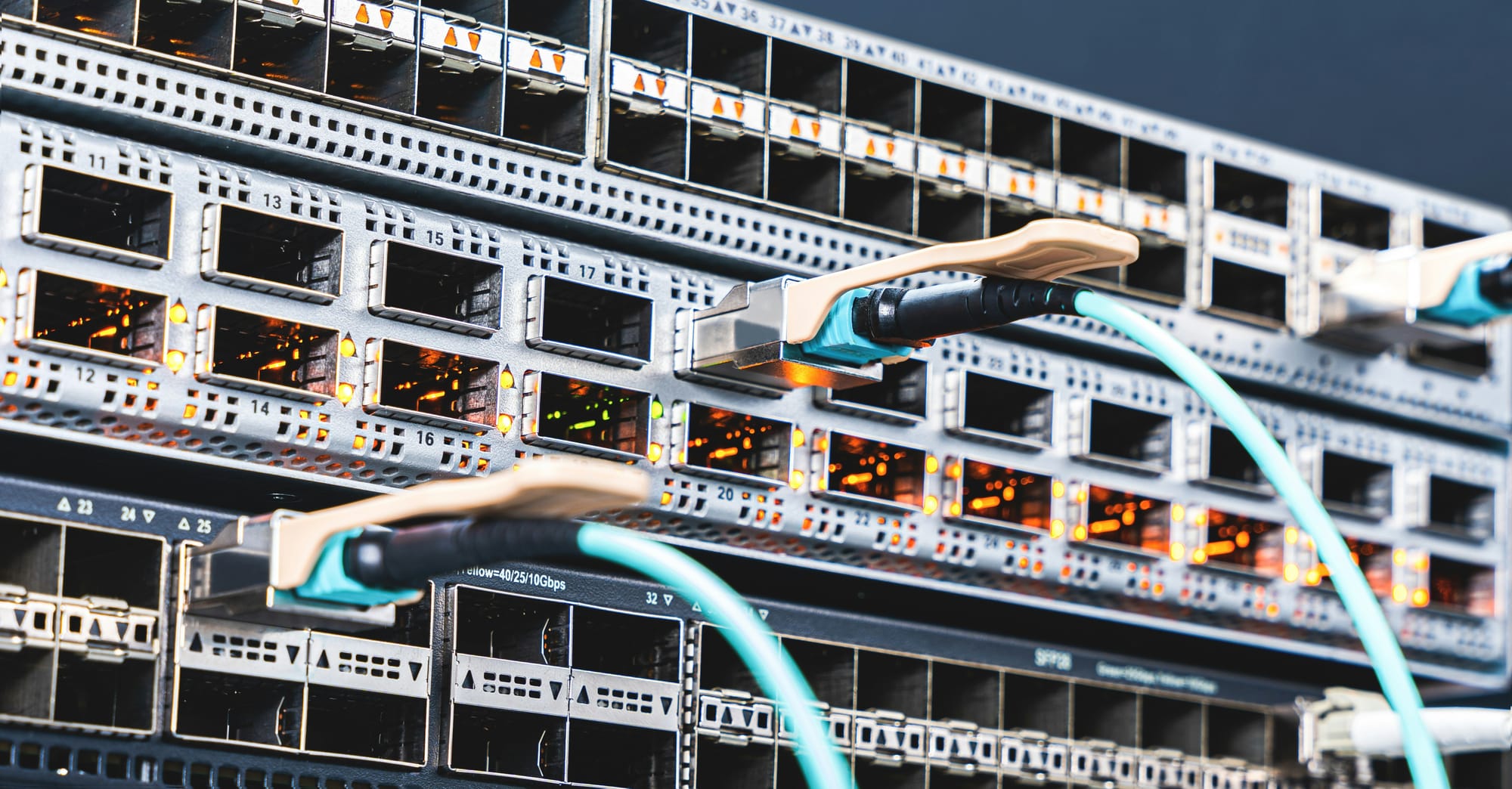 Close-up of network switches with Ethernet cables connected in a data center server rack.