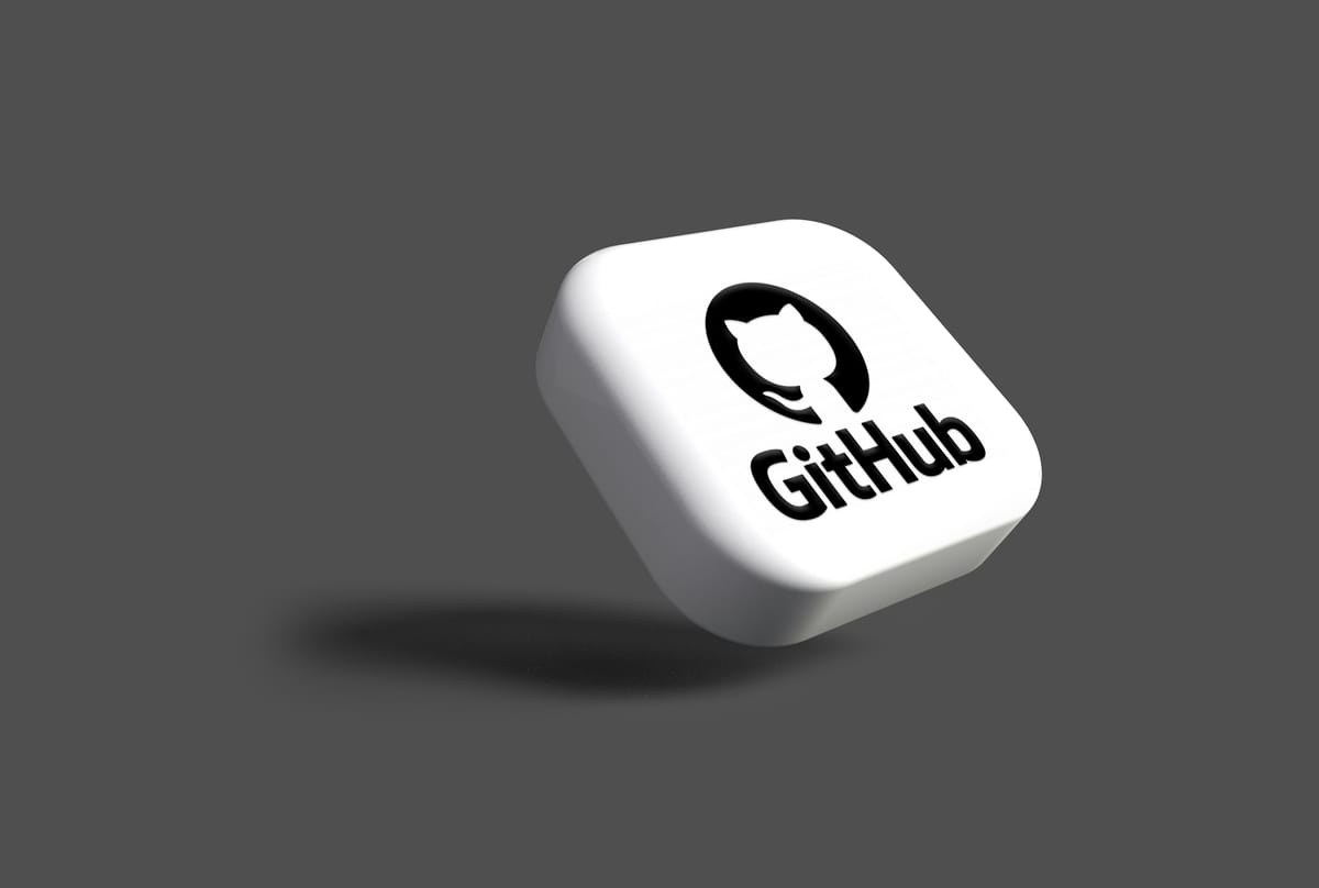 GitHub logo and mascot on tile leaning on a grey background.