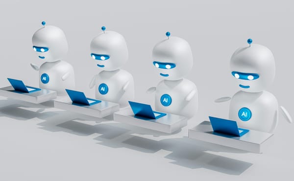 Four identical robots working on laptops.