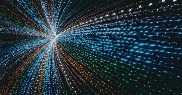 Abstract burst of multicolored light trails converging toward a vanishing point on a dark background