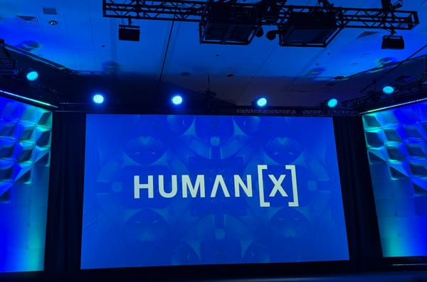 Human[X] logo on blue background on main stage at HumanX conference.